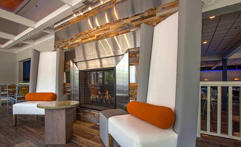 Two chairs between a fireplace