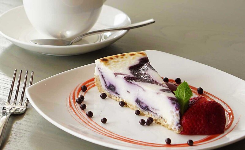 Cheesecake dessert with strawberry garnish