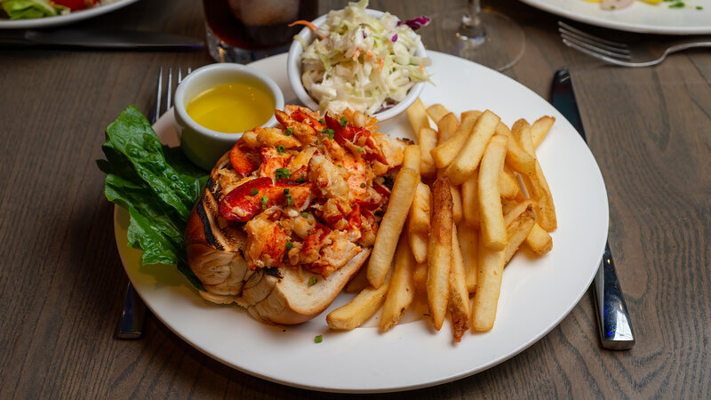 Lobster roll sandwich with side of french fries